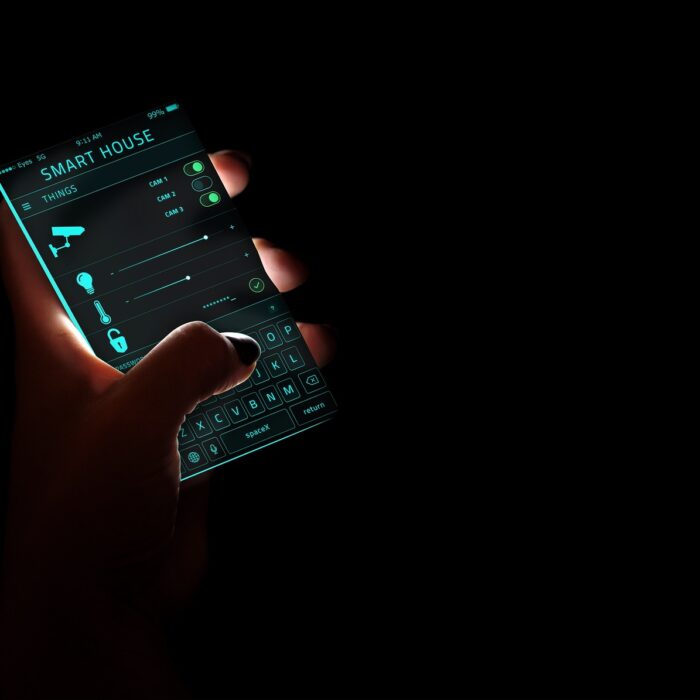 Smartphone in hands with "SMART HOUSE" application open on screen
