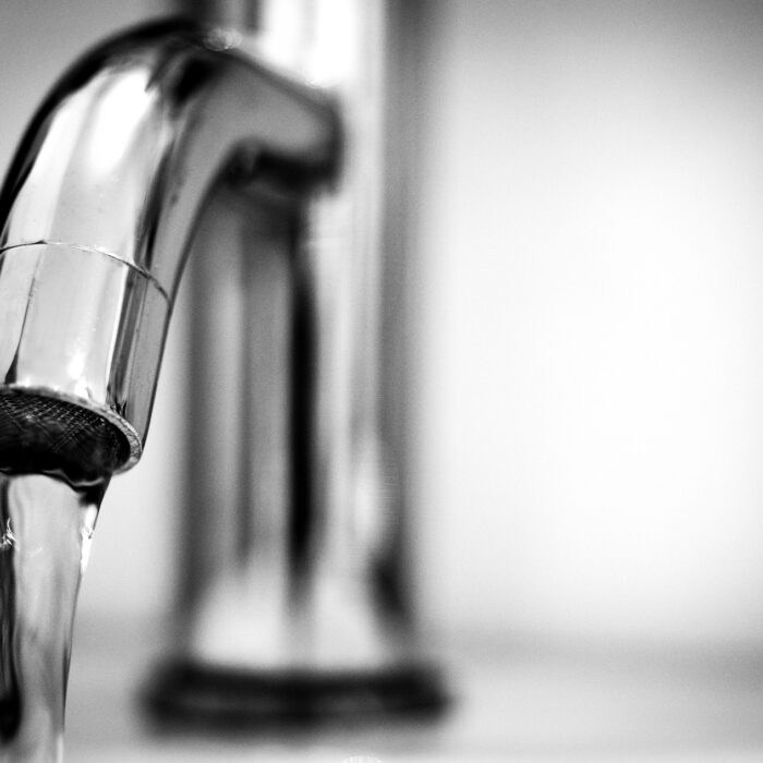 Silver sink faucet tap on with running water
