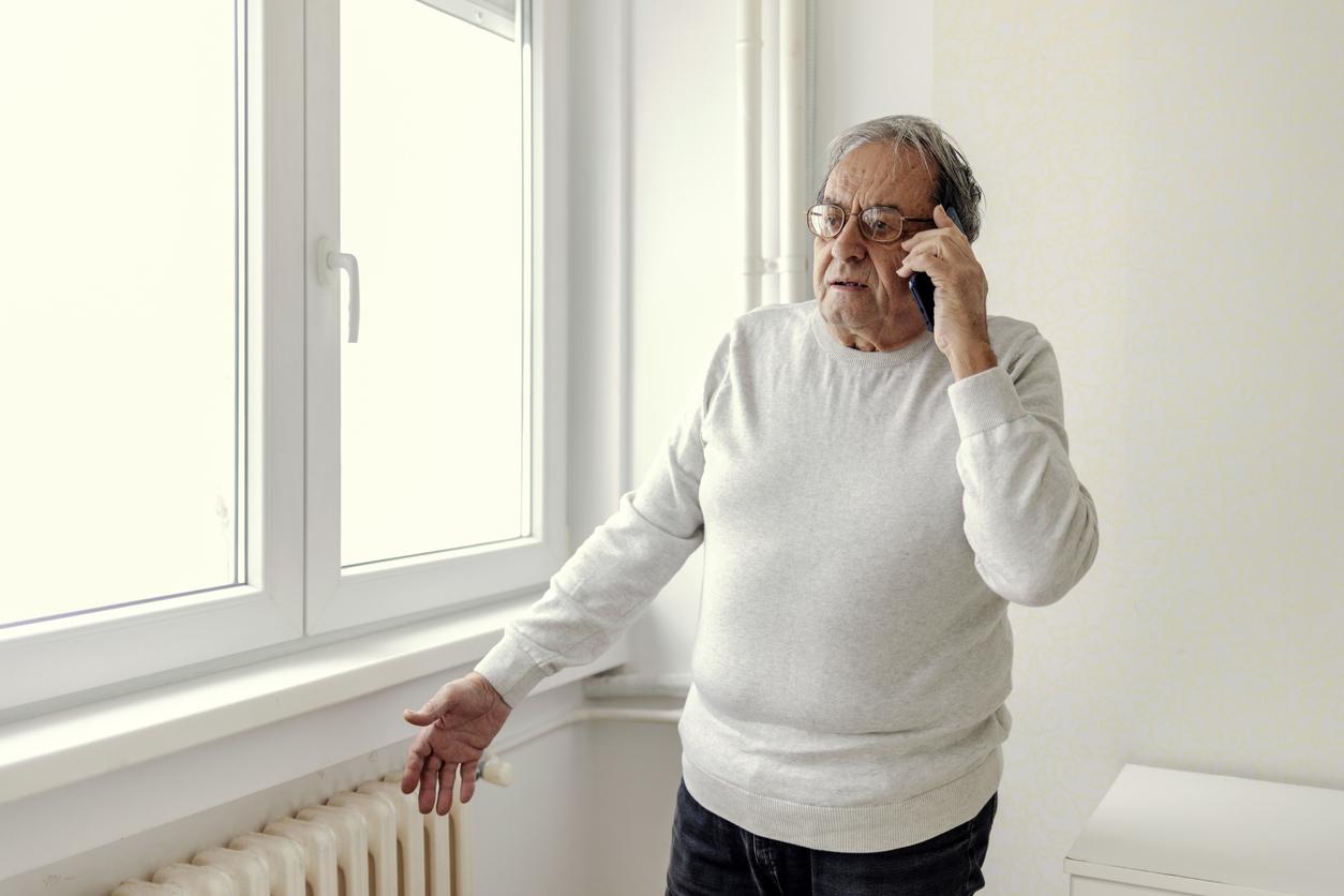 Man calls the repair service due to a problem with the cold radiator.