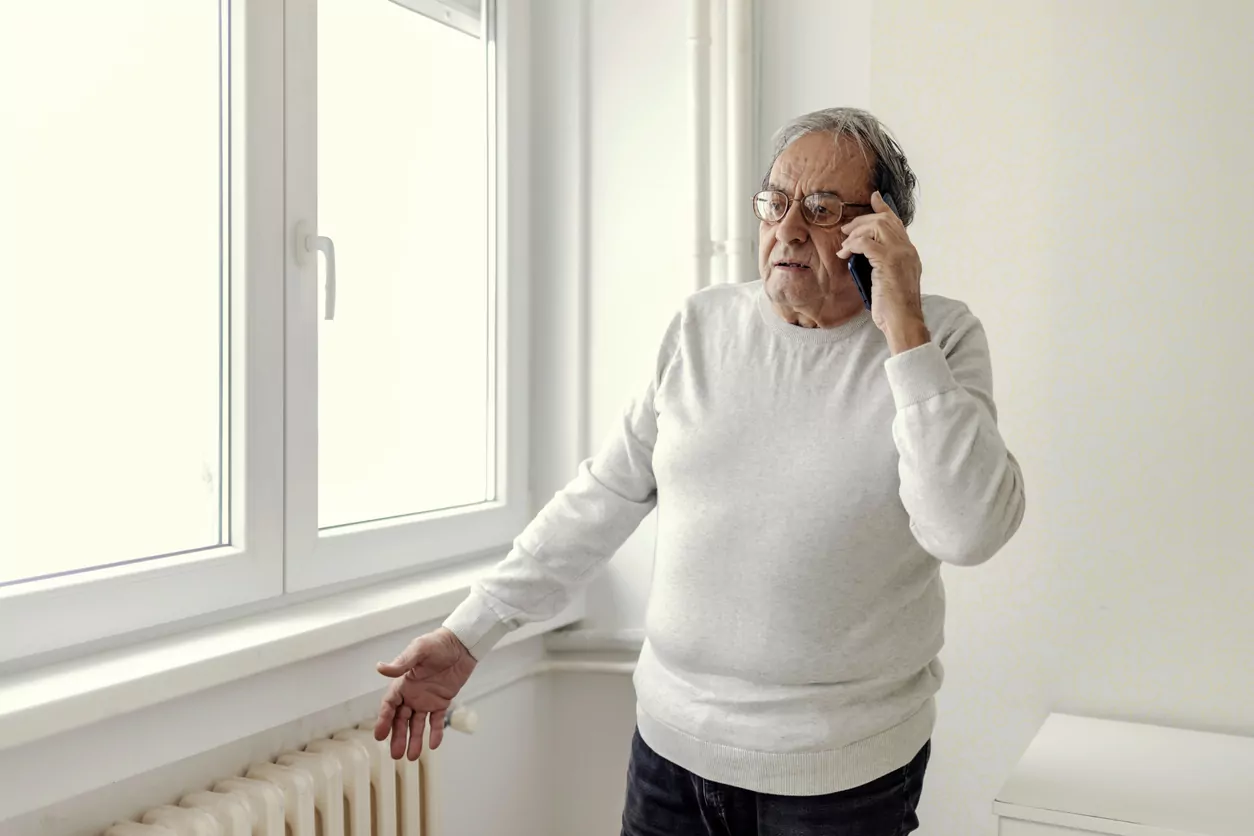 Man calls the repair service due to a problem with the cold radiator.